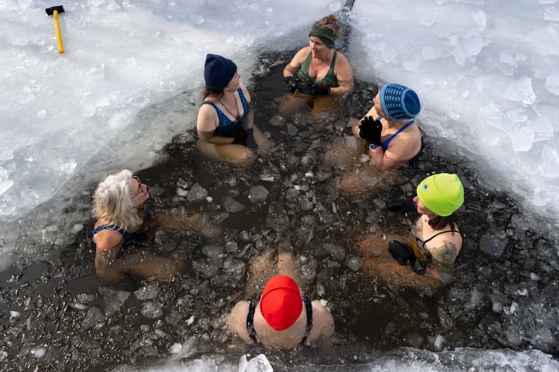 Athlete recovering in a cold plunge tub after an intense gym workout