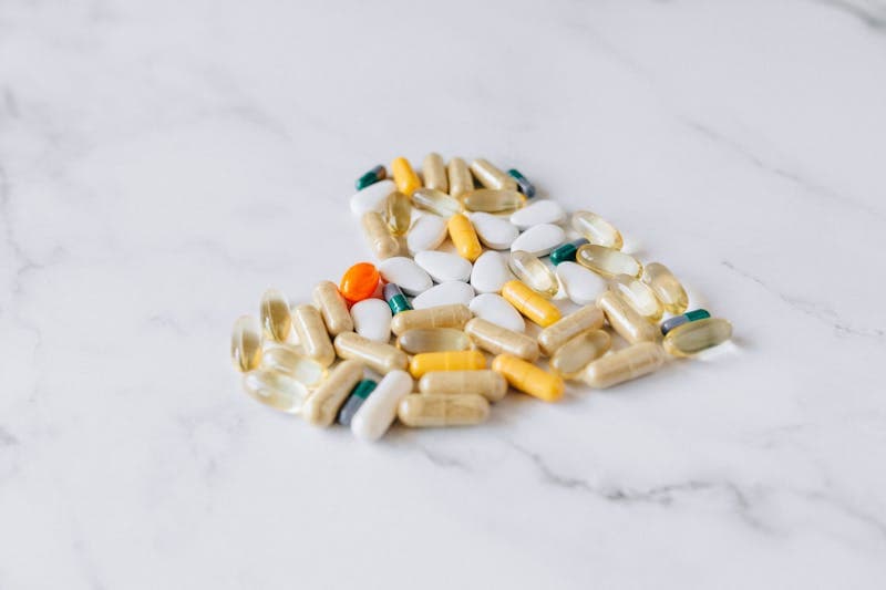 Fish oil capsules with dosage chart showing recommended omega-3 intake by health goal