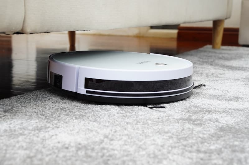 Person using a cordless stick vacuum on carpet — manual control and precision