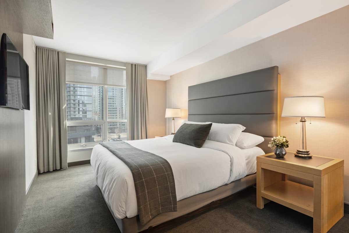 Sleep mask and blackout curtains side by side in a bedroom — which blocks more light for better sleep?