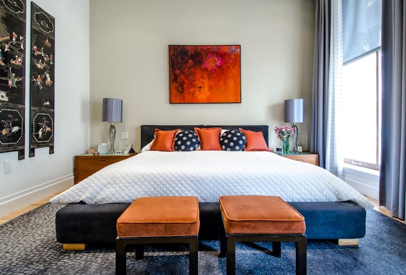 Weighted blanket and regular blanket side by side on a bed — which helps you sleep better?