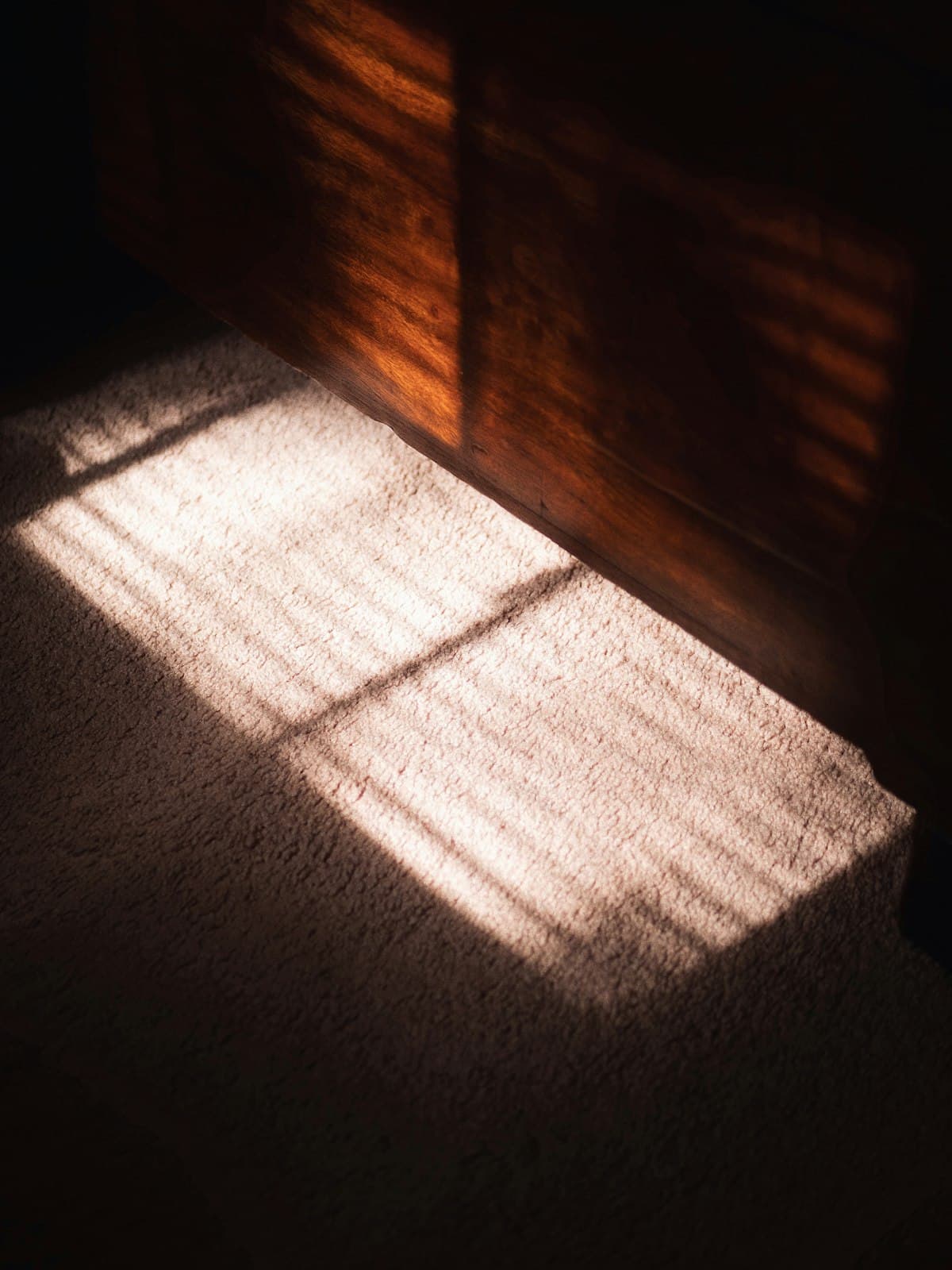 Warm morning sunlight streaming through a window onto the floor, illustrating the ideal early-morning window for taking NMN