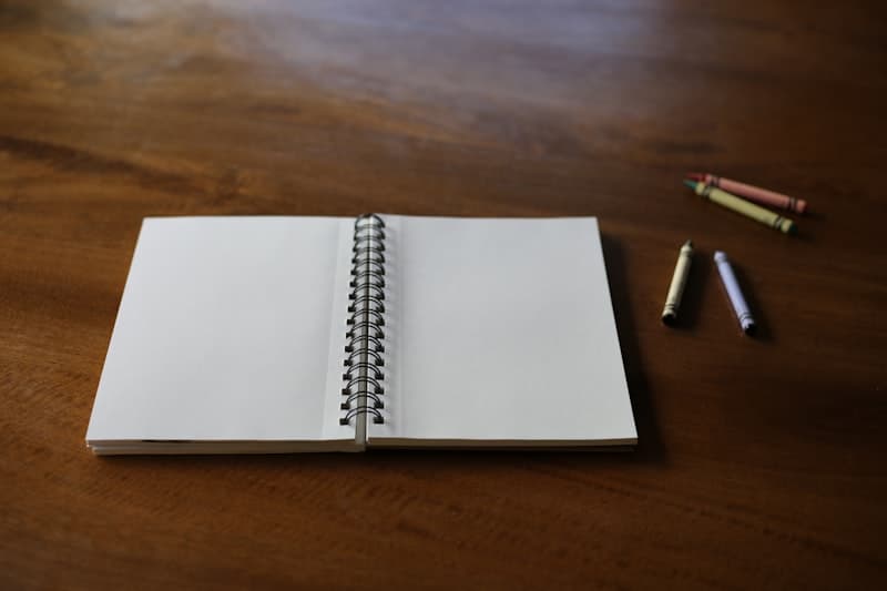 Open notebook with a pen resting on a wooden table, representing a dream journal used to track vivid dreams and decide if they are normal or a warning