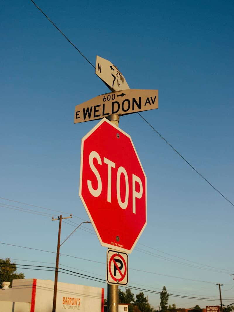 Red stop sign on a street, marking the red-flag symptoms where you should stop ashwagandha and consult a clinician