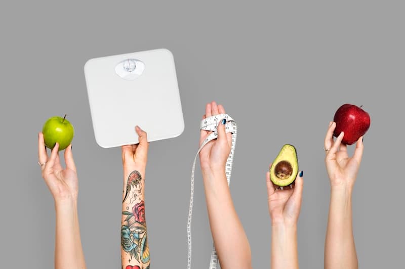 Hands holding fresh healthy food items — goal-based protein planning for weight loss and fitness