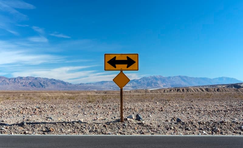 Road signpost pointing in opposite directions