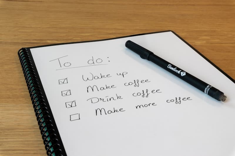Handwritten to-do checklist in a spiral-bound notepad with a pen — diagnosing your bloating cause and matching the fix