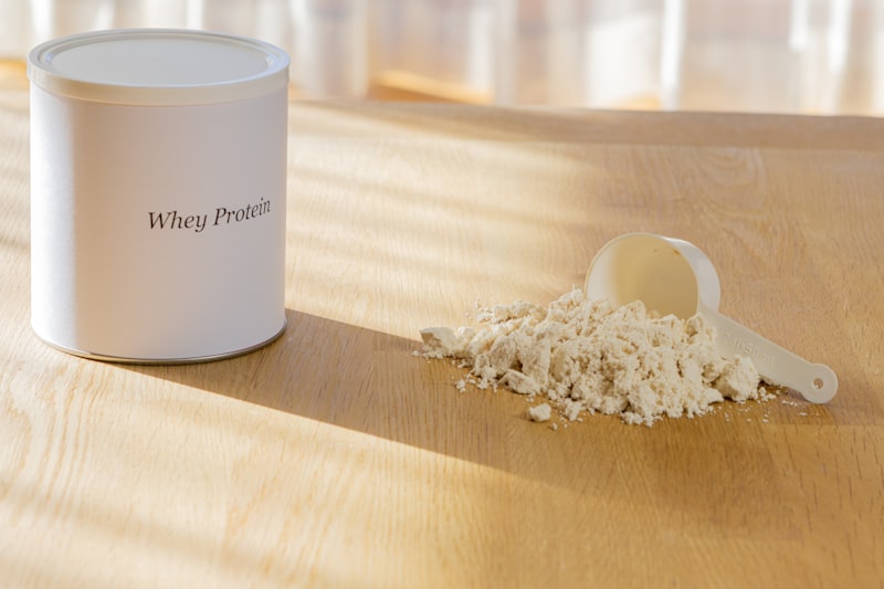 Whey protein powder with scoop on wooden surface — supplement vs whole foods comparison