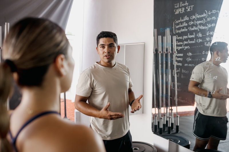 Person checking their form in a gym mirror -- avoiding beginner mistakes