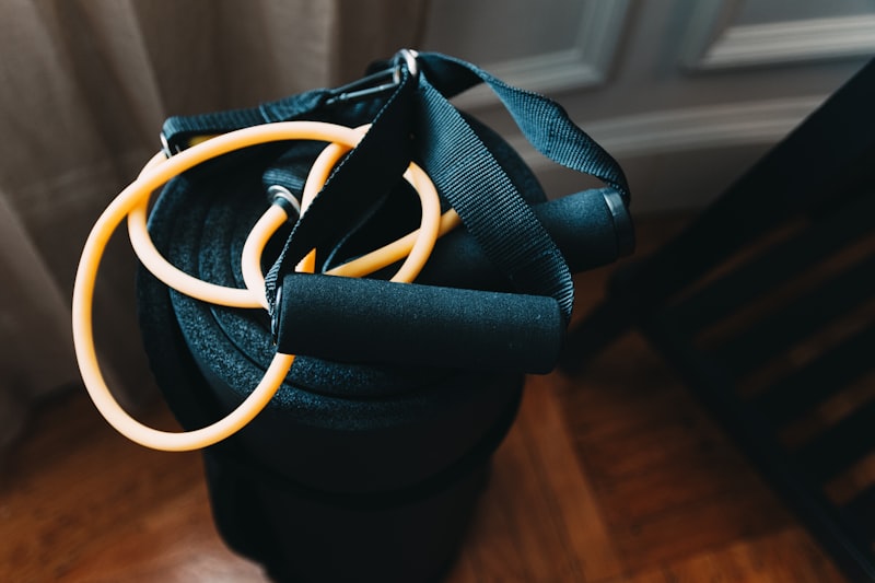 Person exercising with resistance bands in a living room -- strength training at home